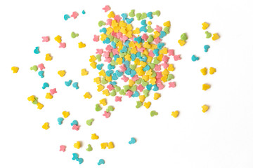 Candy sprinkles. Colorful cake sprinkles scattered over white background.