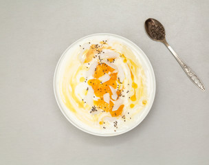 Fresh mango smoothie bowl with coconut, granola and chia. Healthy vegan diet breakfast concept.