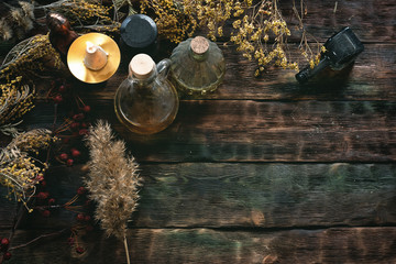 Witch doctor concept. Witchcraft background with copy space. Dried herbs and liquids in a bottles...