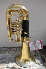 Tuba from a brass band in cobblestone street