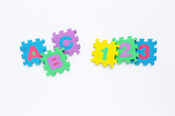 Alphabet puzzle with number puzzle on white background.