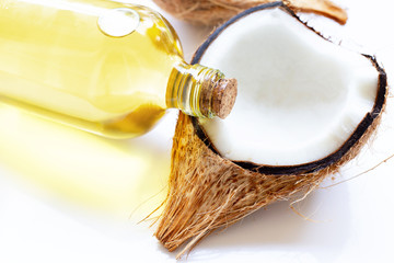 Coconut oil with coconuts on  white