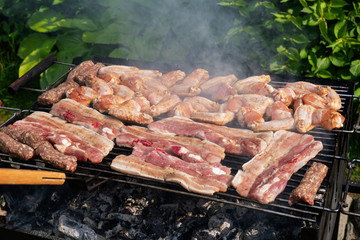 Grilling pork and chicken at a barbecue party