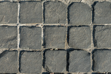 The road of square stones. Background of gray old stone