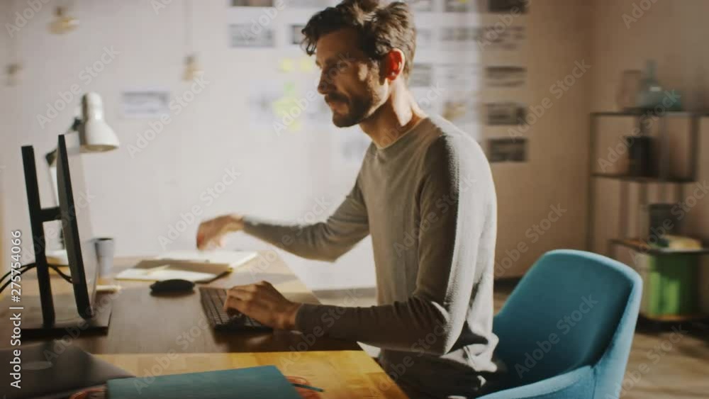 Poster Designer Sitting at His Desk in Office Studio Working on a Desktop Computer with Smartphone Software Development Application on Screen. Energetic Fast Paced Time-Lapse. 360 Degree Tracking Arc Shot