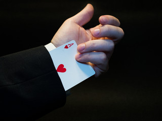 Businessman pulling an ace from his sleeve. Advantage and strategy concept.