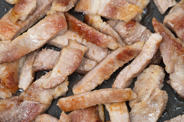 Top view of delicious grilled pork in iron pen.