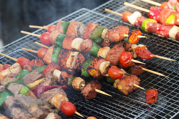 Barbecue grill with various kinds of meat and vegetable .