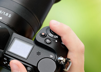 Hand holds SLR camera close-up