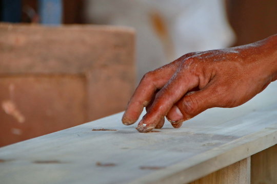 Carpenters work on woodworking machinery in carpentry shops