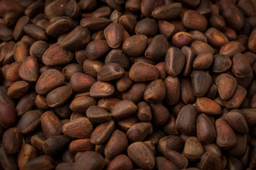 inshell pine nuts on a wooden background. Background Texture