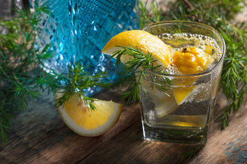 Cocktail with blue gin , tonic and lemon on a old wooden table .