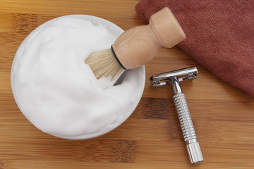 Shaving accessories on wooden background.