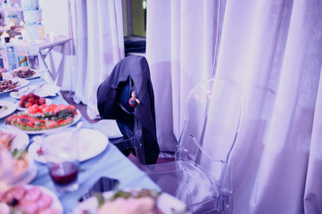 Burning candles on a festive table. A festive table with candles