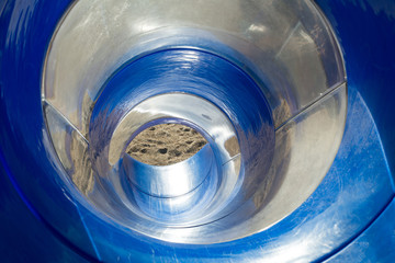 Colorful reflection in steel round slide.