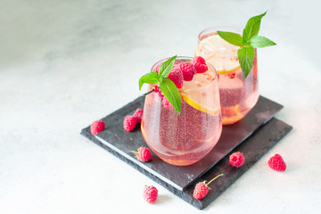 Sparkling pink raspberry lemonade on grey background