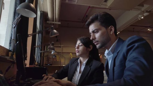 Attractive business colleagues in suit share and jumps, celebrate, happy, laugh, smile, flirt, high five, jump with joy, hug at their victory, success, promotion at work. 4k 60fps handheld stabilized