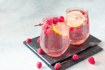 Fototapeta Sparkling pink raspberry lemonade on grey background obraz