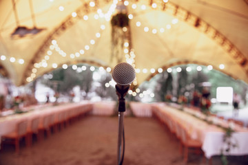 Stand with a microphone at the party. Stand with a microphone at a wedding