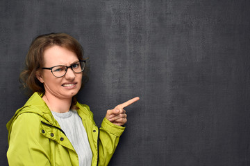 Portrait of girl pointing at something unpleasant