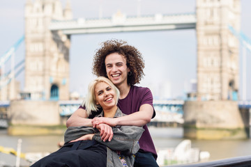 Happy couple hugging at the Tower Bridge