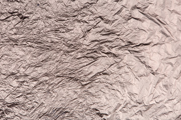 Аluminium foil. Dark silver textural background for a site. Crumpled silver paper.  Top view. Place for text.  Flat image. Сhrome texture