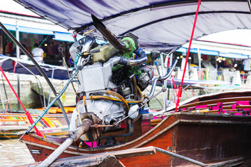 Engine on a longtail boat of amphawa floating market is the tourist most popular in Samut Songkhram, thailand.