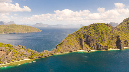 Seascape with tropical islands. El Nido Palawan National Park Philippines. Rocky islands covered with forest. Small lagoons with white beaches. Boat tours between the islands.