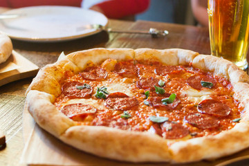 Delicious pizza served on wooden table pizza in restaurant