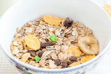 Healthy breakfast of muesli with pieces of fruit in bowl