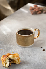 coffe with chocolate croissant on grey background