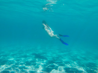 Woman diving in clear turquoise water