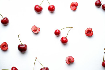 Obraz na płótnie Canvas Creative summertime berry layout made of seasonal summer fruits. Healthy food. Cherries on white background