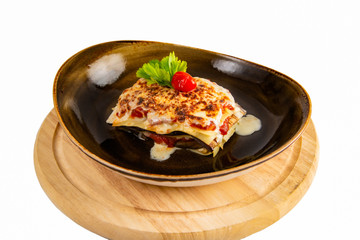 Delicious lasagne bolognese with mushrooms parmesan cheese in a brown cup isolated on white background