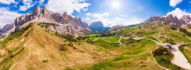Dolomites - Beautiful panoramic sunset landscape at Gardena Pass (Passo Giau) near Ortisei. Stunning airial view on the top Dolomiti Alps Mountains from drone on summer day, Italy, south Tyrol Europe