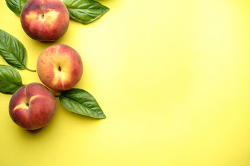 Healthy food, clean eating, summertime background. Fruit layout made of sweet ripe peaches on yellow table