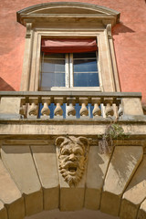 frontal of palazzo manzoli malvasia and it's devil carving face with wondow of Bologna Italy 