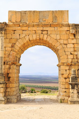 Fototapeta na wymiar Arches at the ruins of Volubilis, ancient Roman city in Morocco.