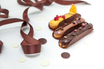 Closeup of Set of several eclairs with various fillings and design isolate on a white background, the concept of French cuisine