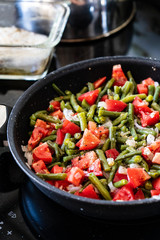 Green beans with tomatoes in pan