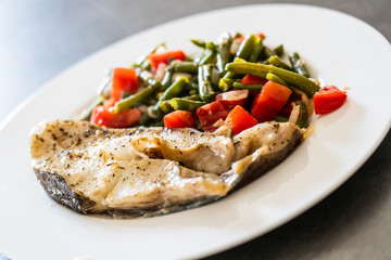 Fish dish - fish fillet in sauce and vegetables