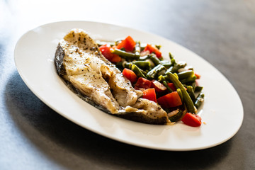 Fish dish - fish fillet in sauce and vegetables