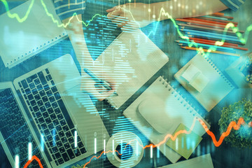 Financial chart drawn over hands taking notes background. Concept of research. Double exposure