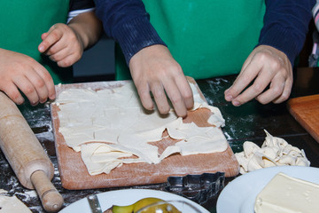 Joint cooking. Cooking with kids. Bake with children. Children in the kitchen. Children's hands.