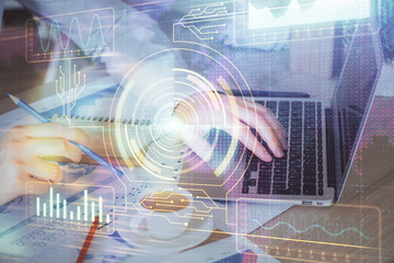 Multi exposure of data internet theme hologram with man working on computer on background. Concept...