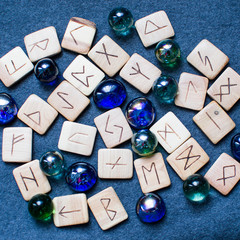 Magic runes for fortune telling and crystals on a blue background