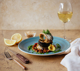 Smoked tasty mackerel with lemon on wooden background