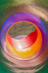 Colorful inside view of a round slide.