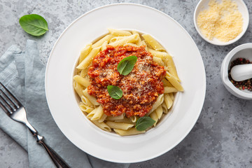 penne pasta with Bolognese sause in white plate