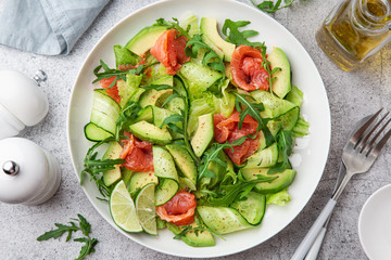 avocado, smoked salmon and cucumber salad on white plate